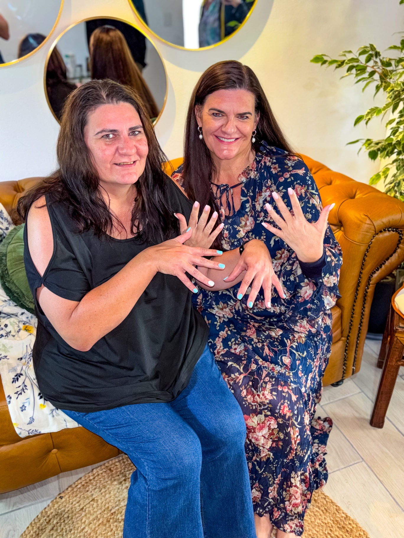 Two clients showing their finished manicures at Botanica Spa Olivedale